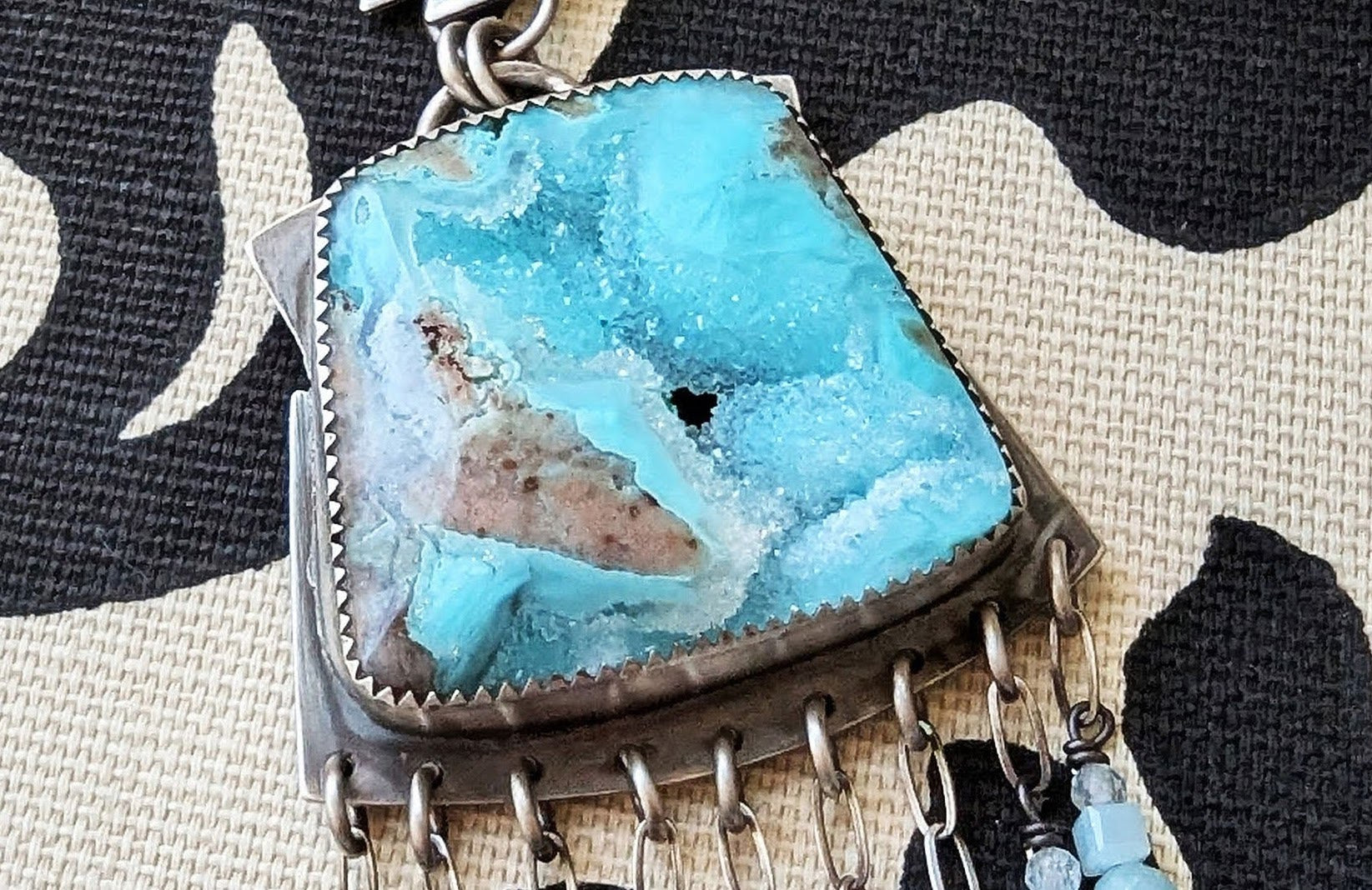 Close up of aqua blue stone with crystallized inclusions 