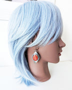 Bold boho earrings featuring spiny oyster shell and chain fringe on mannequin for scale