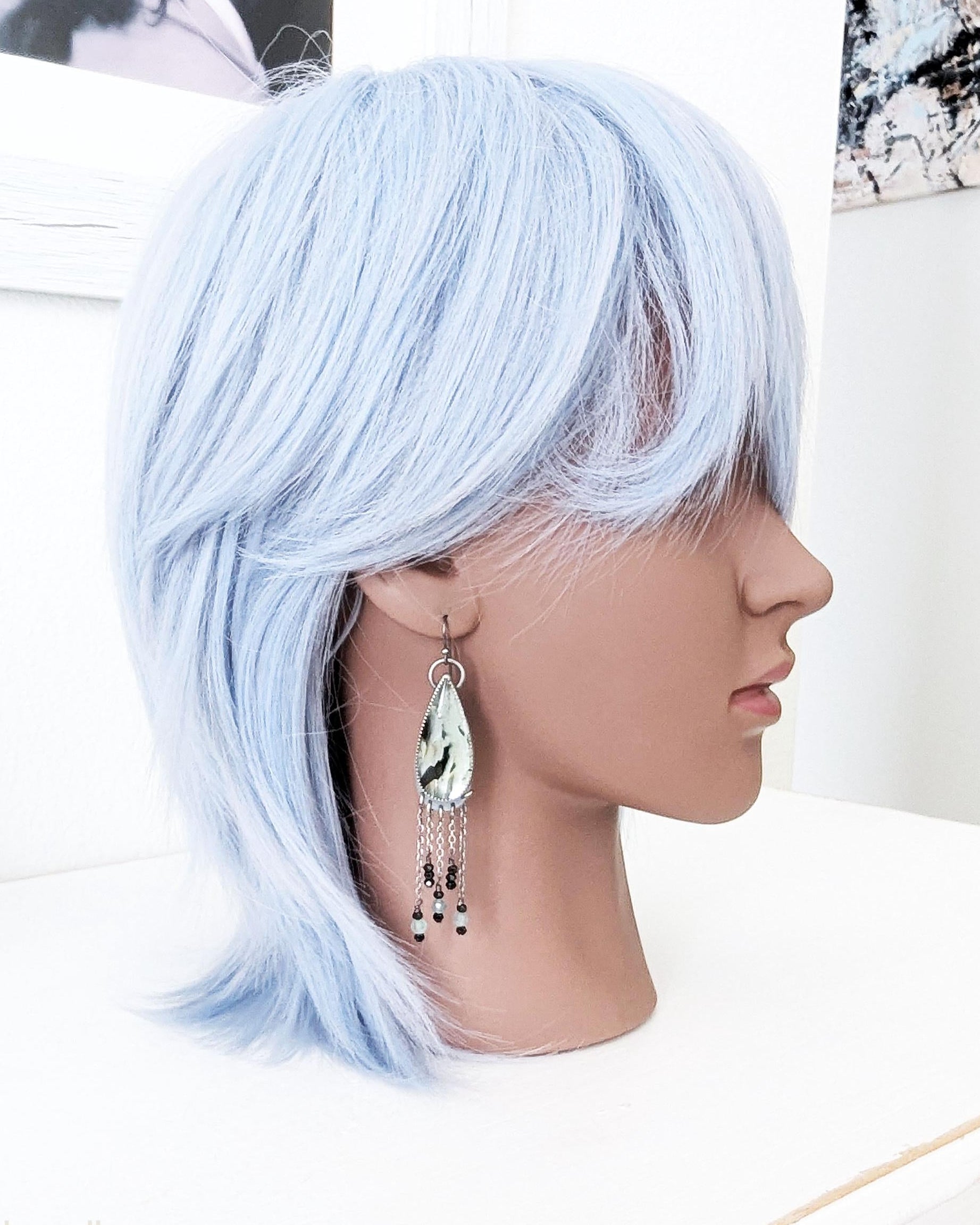 Handcrafted aqua reclaimed glass earrings worn for scale
