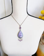 Boho purple statement jewelry pendant shown on bust for scale