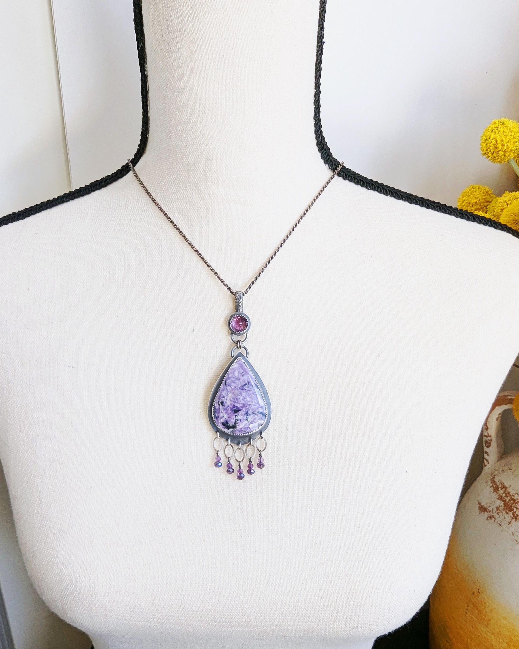 Boho purple statement jewelry pendant shown on bust for scale