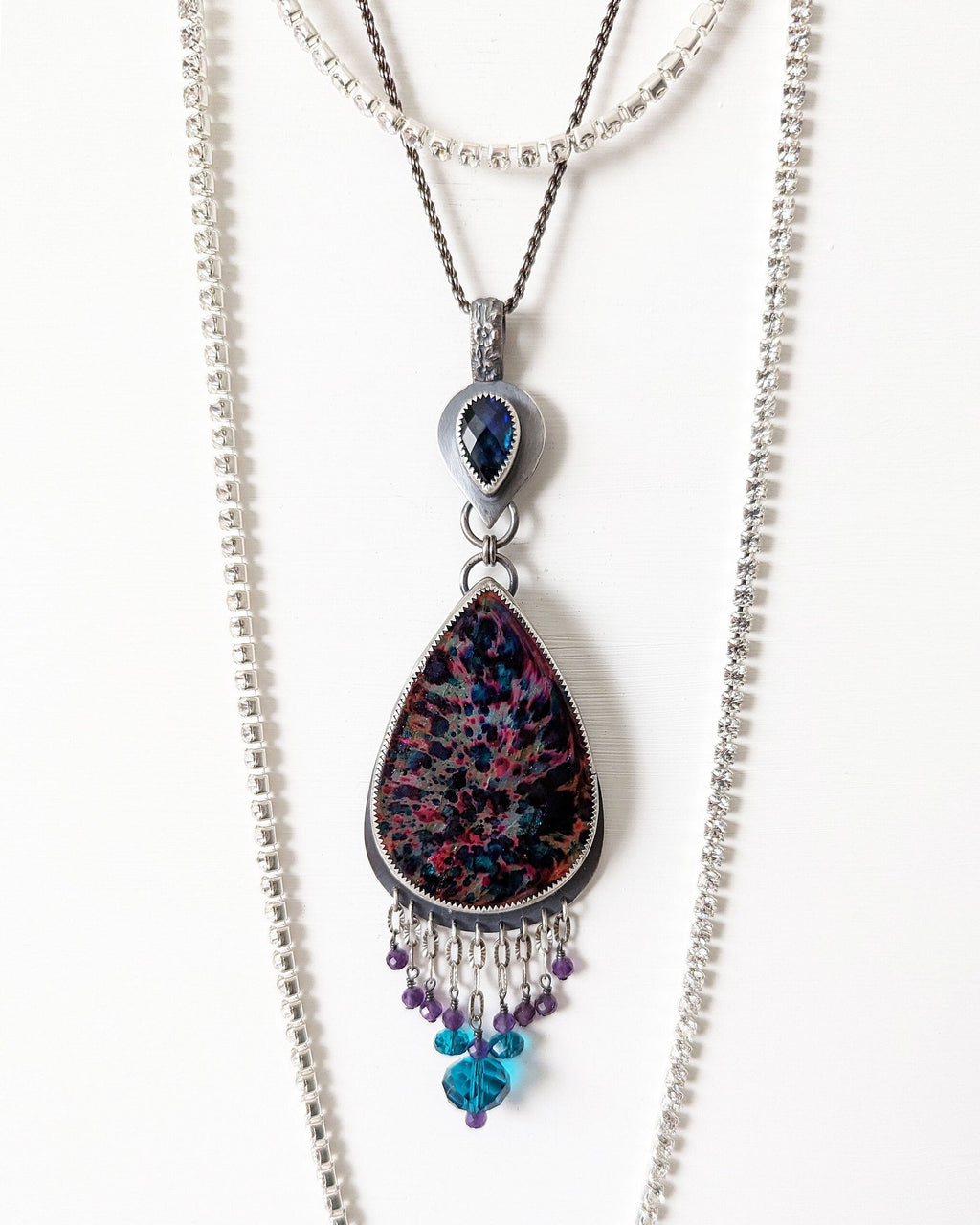 Bohemian luxe statement pendant with amethyst and blue crystal beads in indirect light on chain (not included)