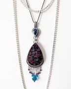 Bohemian luxe statement pendant with amethyst and blue crystal beads in indirect light on chain (not included)