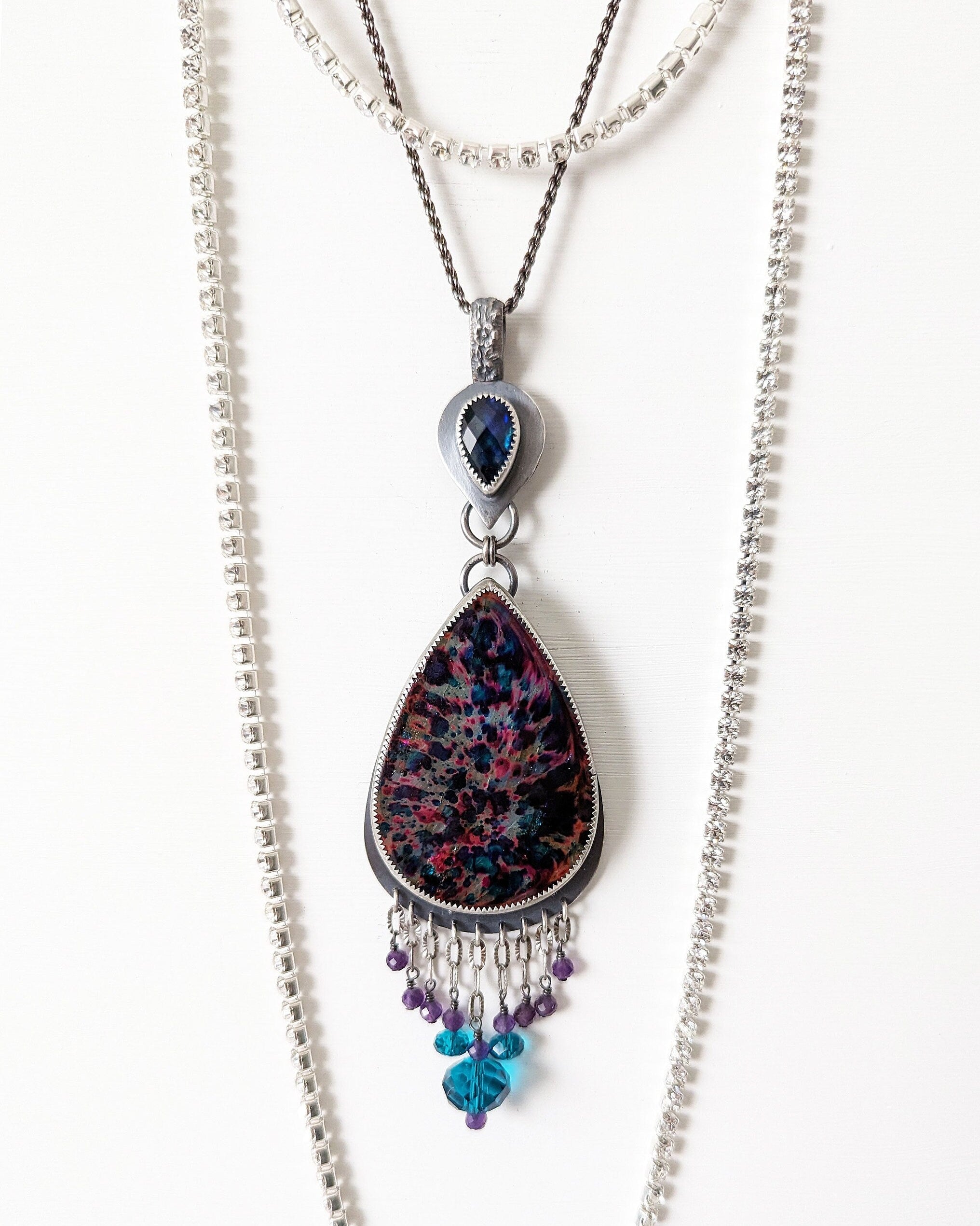 Bohemian luxe statement pendant with amethyst and blue crystal beads in indirect light on chain (not included)
