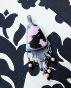 Hand-cut oxidized silver step design with symbolic pink stone
