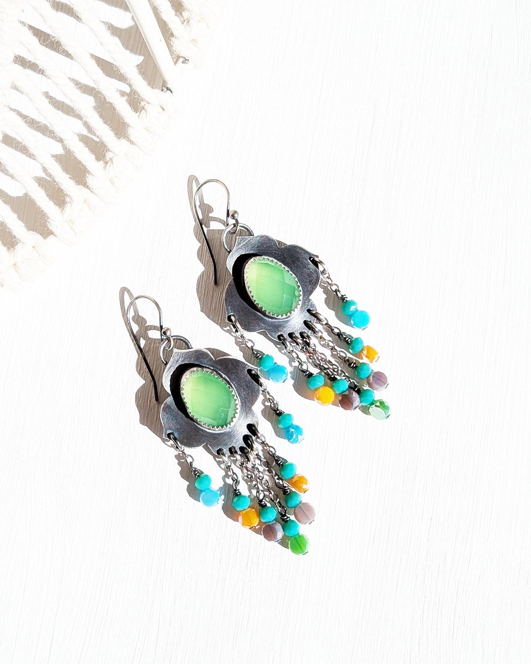 Curvy sterling silver frame with vibrant dyed green gemstone
