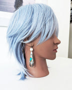 Modern earthy statement earrings with opalized wood gemstone drops on mannequin for scale