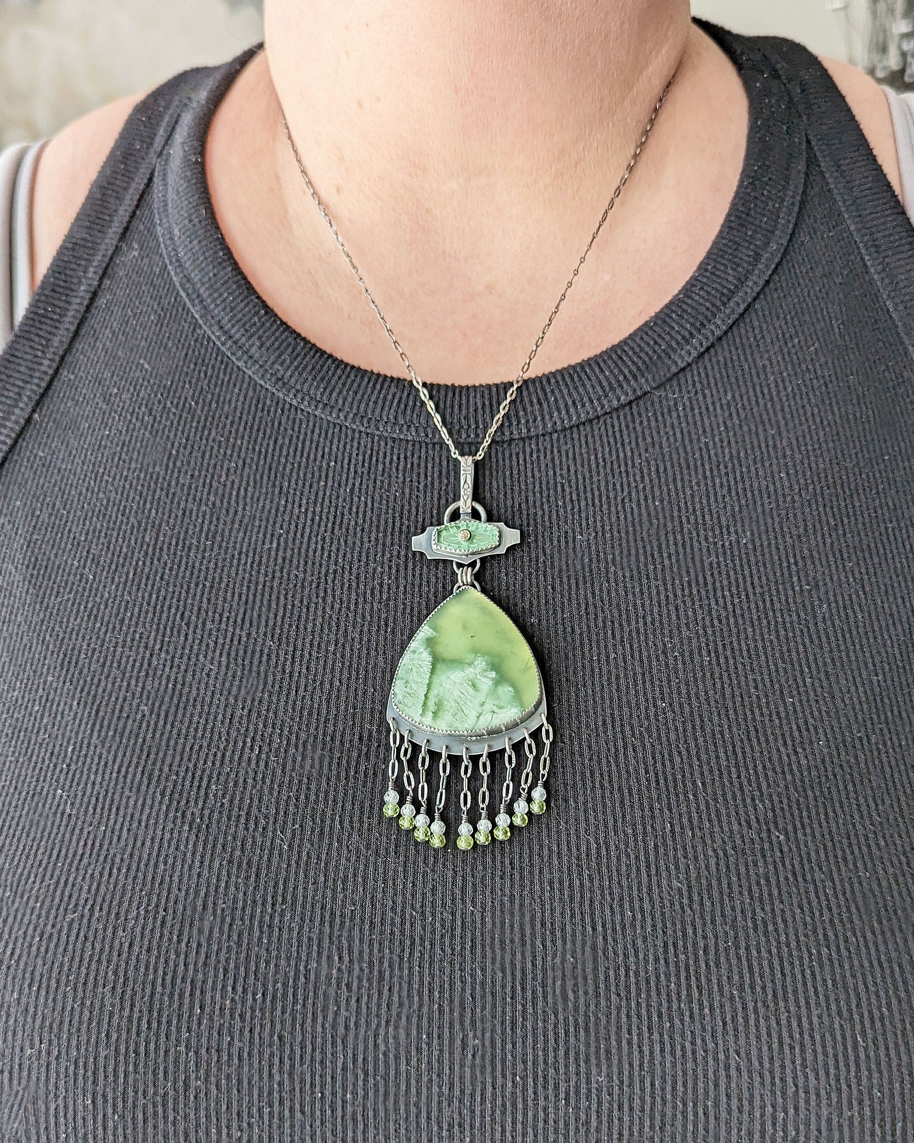 One of a kind green gemstone statement jewelry pendant by Rebellenhaus shown on bust for size