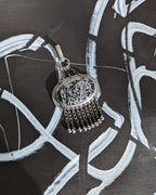 Chain fringe with black spinel and silver-coated pyrite on obsidian pendant
