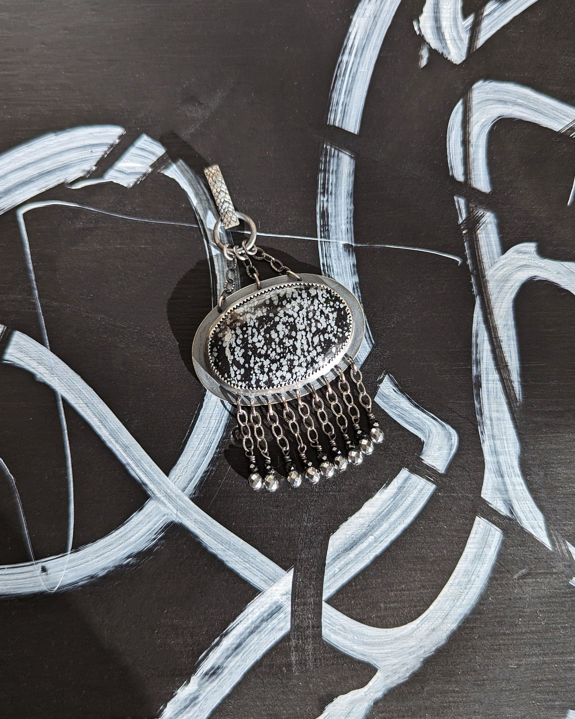Chain fringe with black spinel and silver-coated pyrite on obsidian pendant
