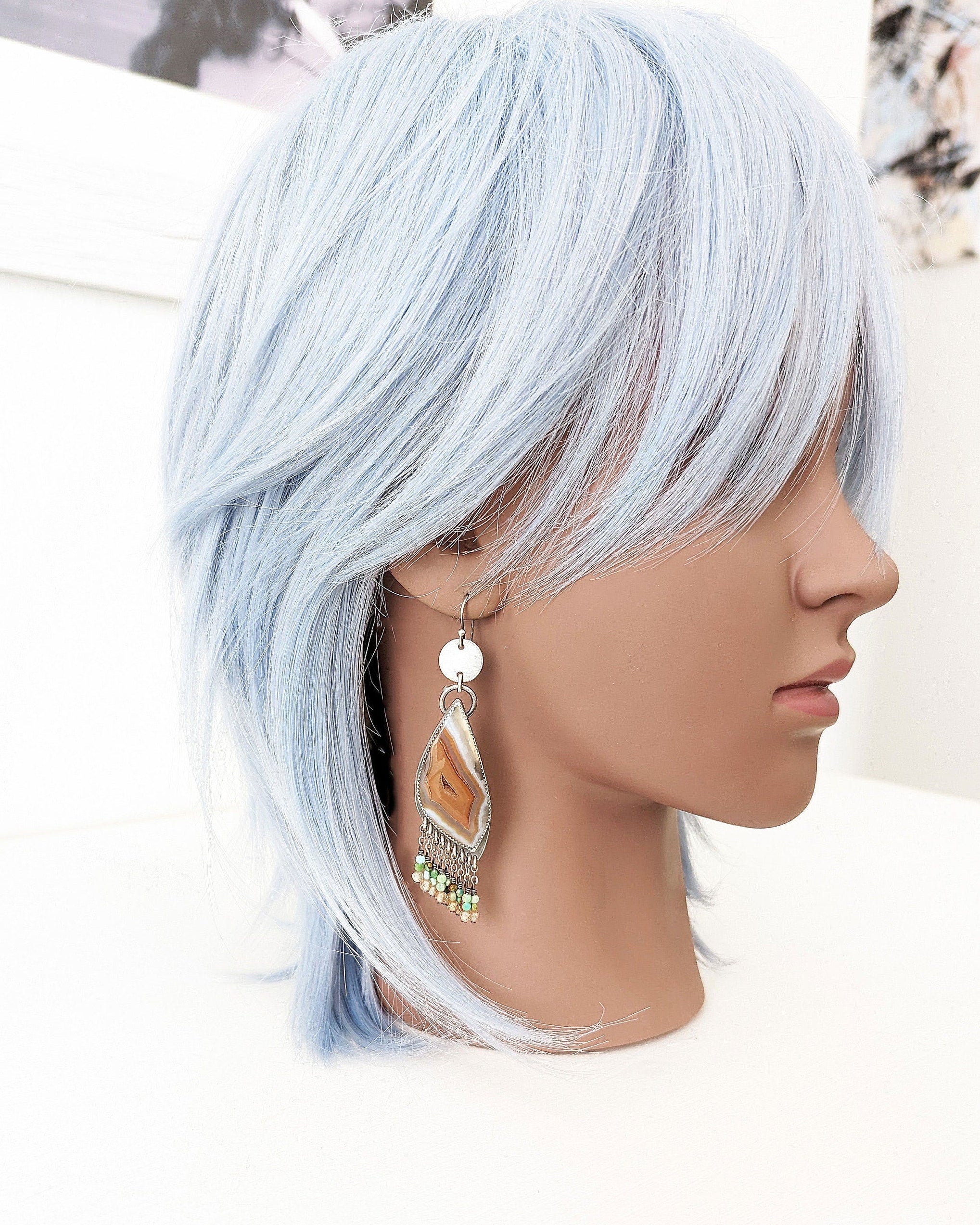 Statement drop earrings with neutral agate and bright turquoise stones on mannequin for scale
