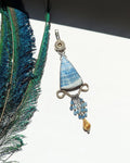 Triangular scheelite pendant with brass filigree detail