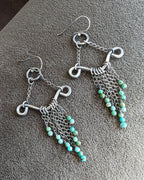 Artisan filigree drop earrings with flowing silver chain detail