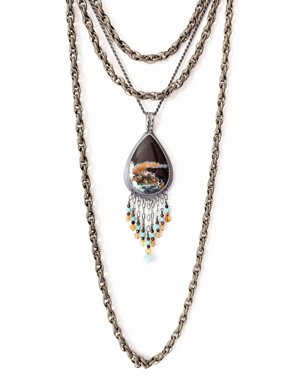 Artisan sterling silver necklace with warm autumn ocean hues shown on chain with layering necklace (not included)