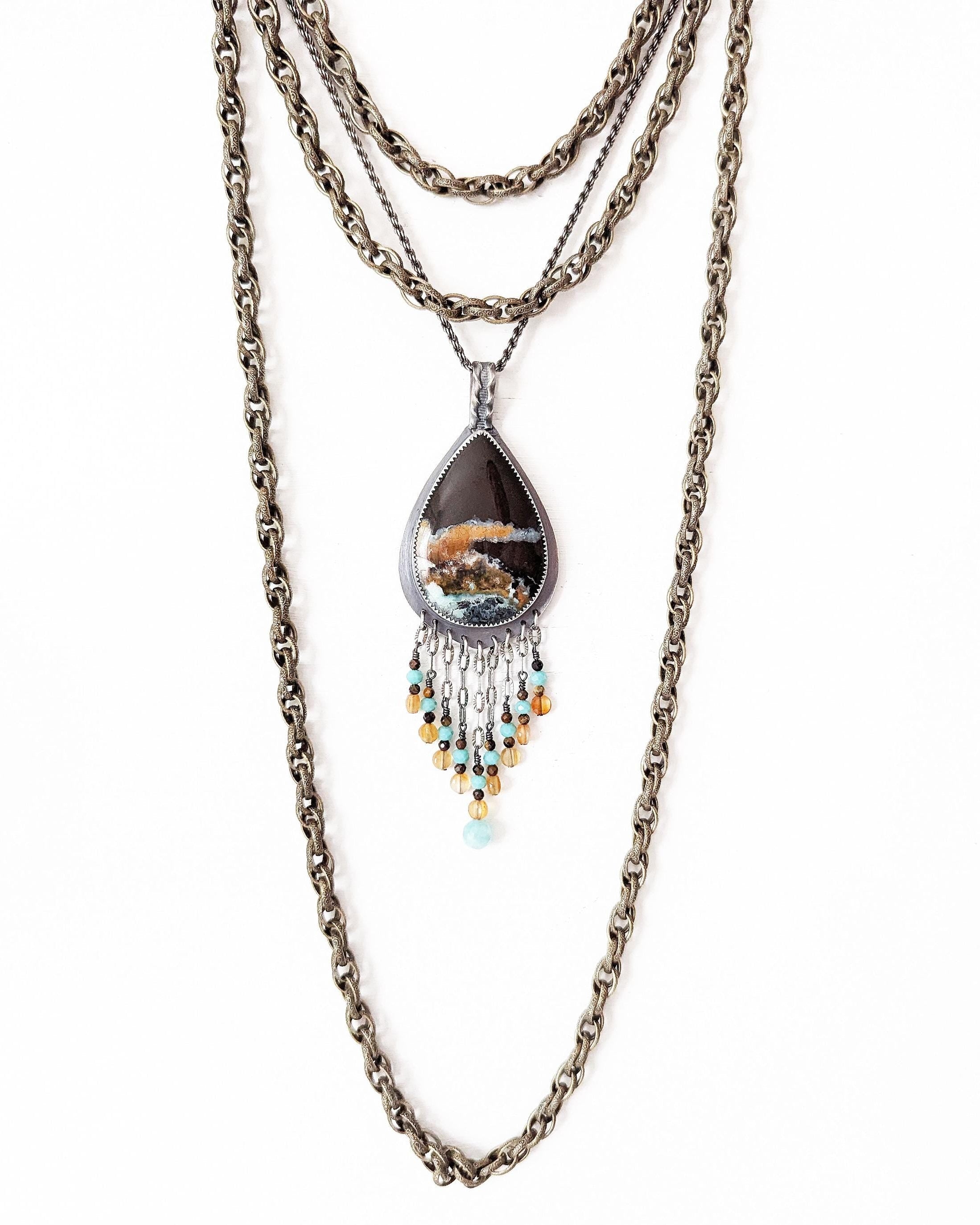Artisan sterling silver necklace with warm autumn ocean hues shown on chain with layering necklace (not included)
