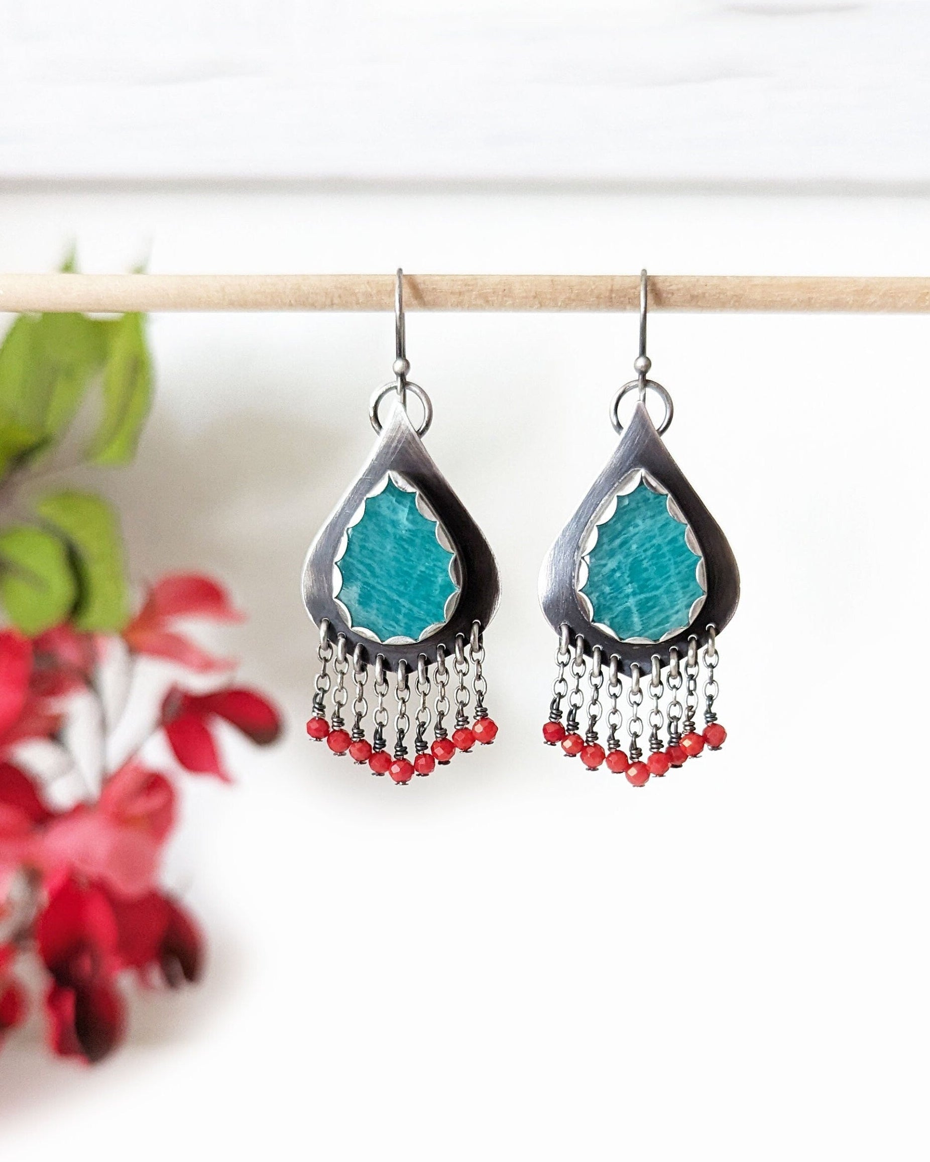 Red coral bead fringe beneath curvy silver drop design