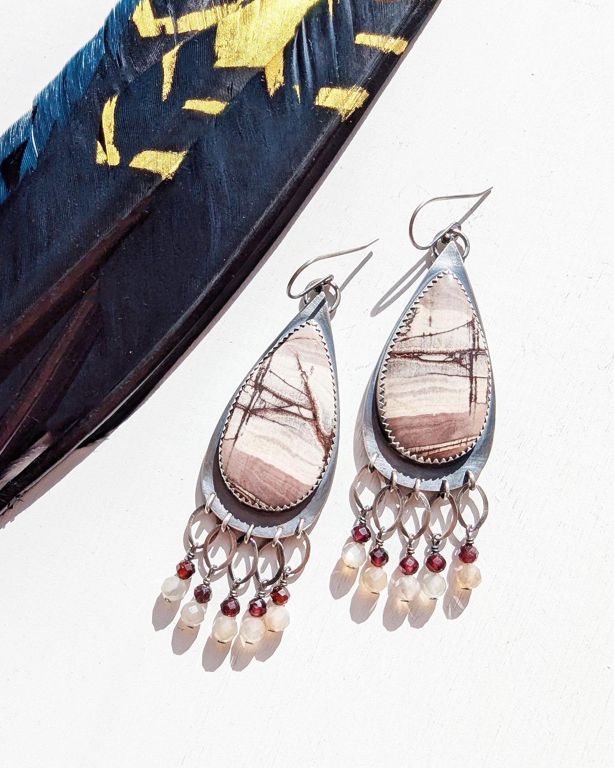 Pear-shaped sterling silver frame with earthy mauve rhyolite jasper