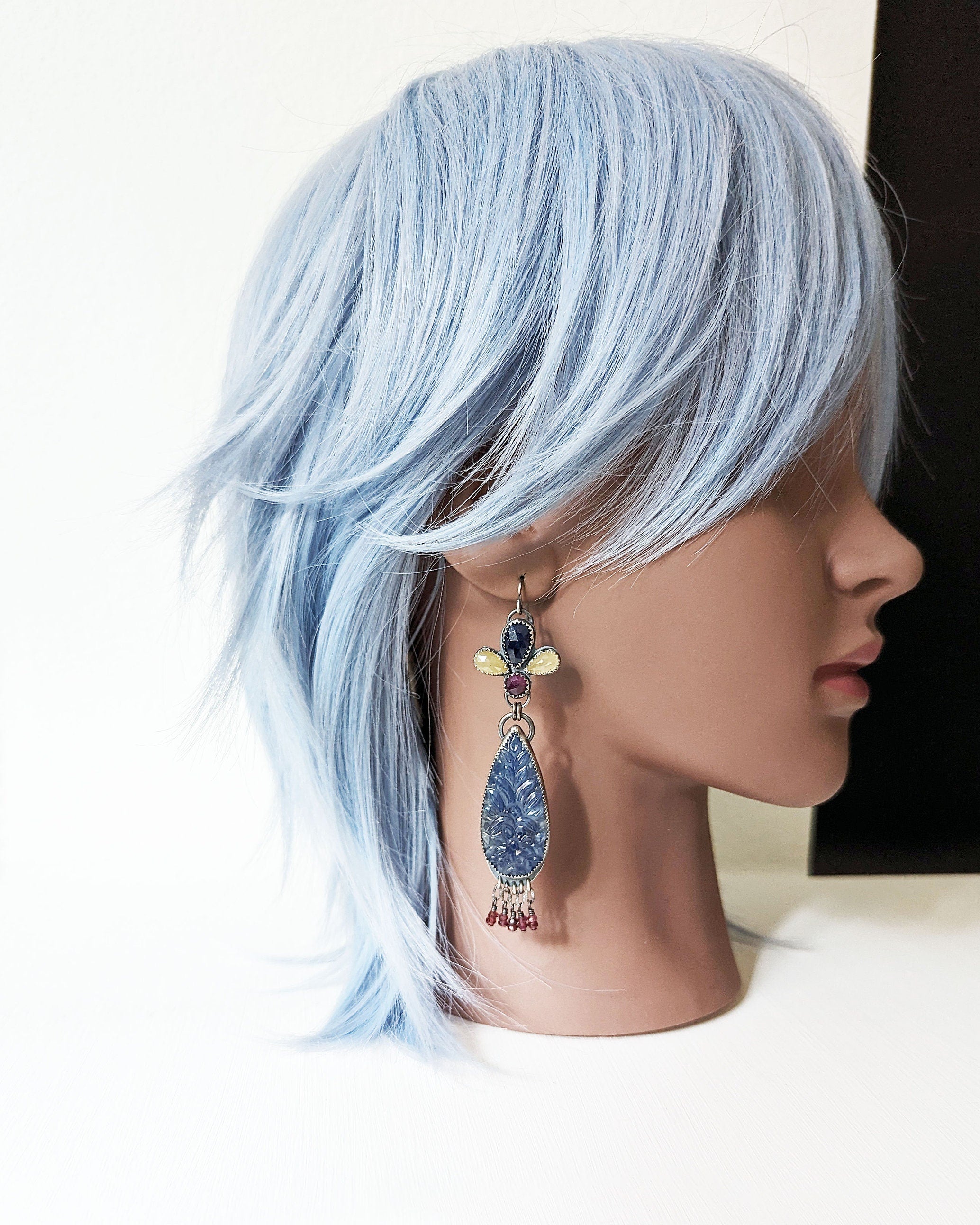 Collector gemstone earrings featuring 69ct sapphire array on mannequin for scale