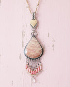 Pink coral and rose quartz bead fringe beneath fossil stone on chain (not included)