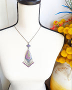 Large artisan stichtite pendant with lavender and lime green veining shown on bust for scale