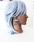 Oxidized sterling silver earrings featuring dramatic fringe movement on mannequin for scale