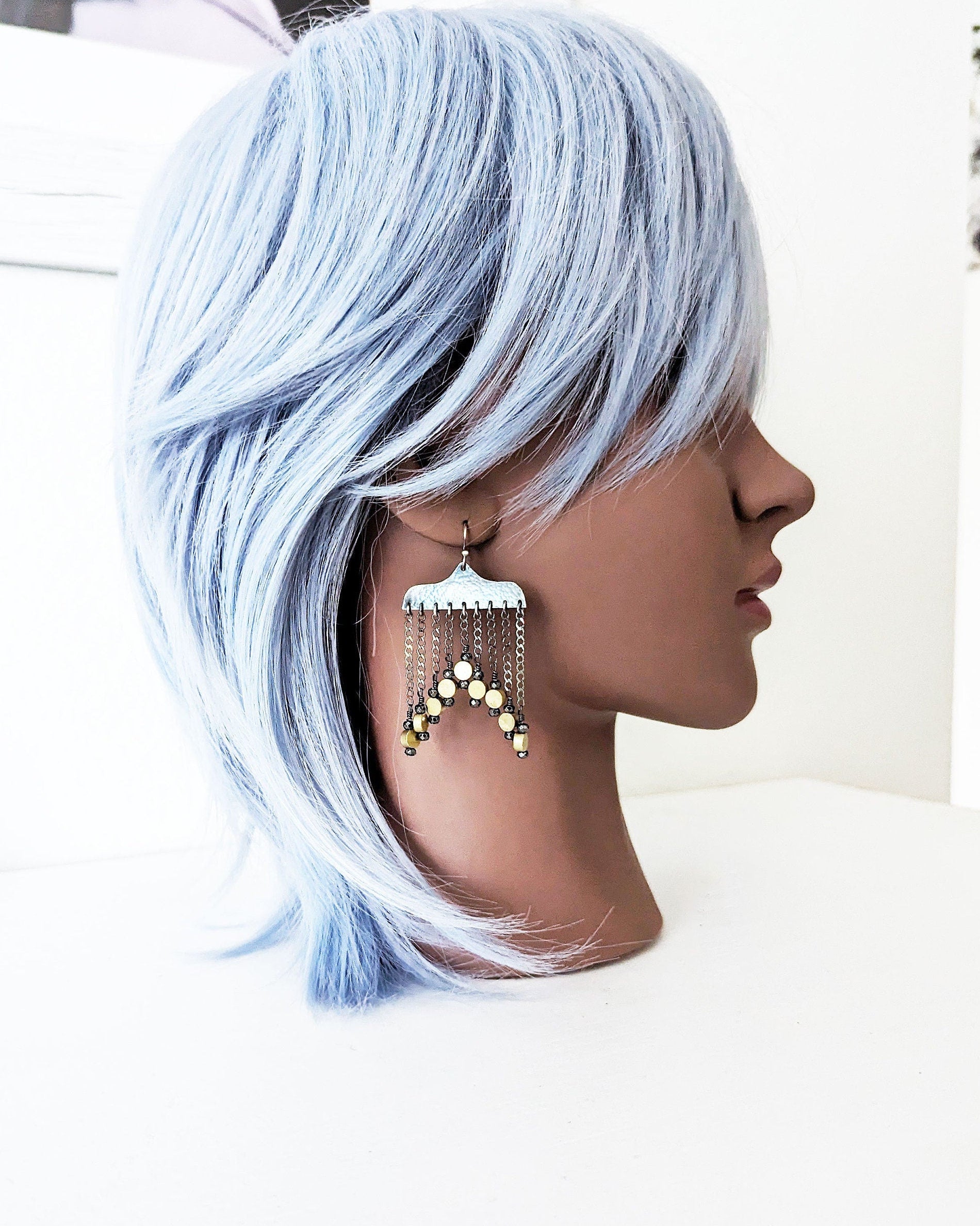 Oxidized sterling silver earrings featuring dramatic fringe movement on mannequin for scale