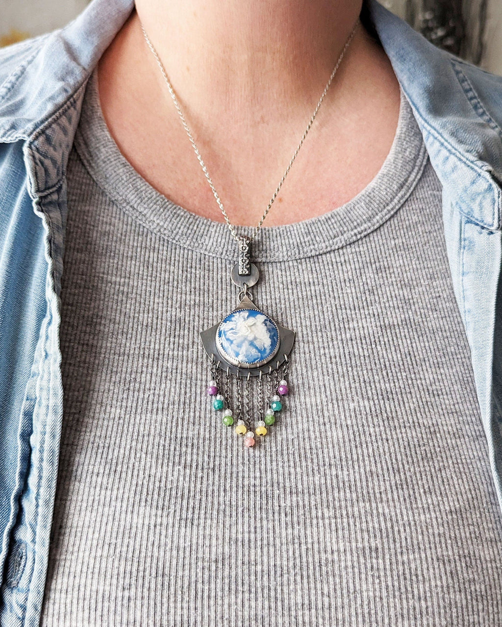 Artisan necklace with lavender, aqua, and pink gemstone accents on bust for scale
