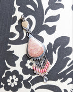 Fossil coral pendant with peach and cream pastel tones