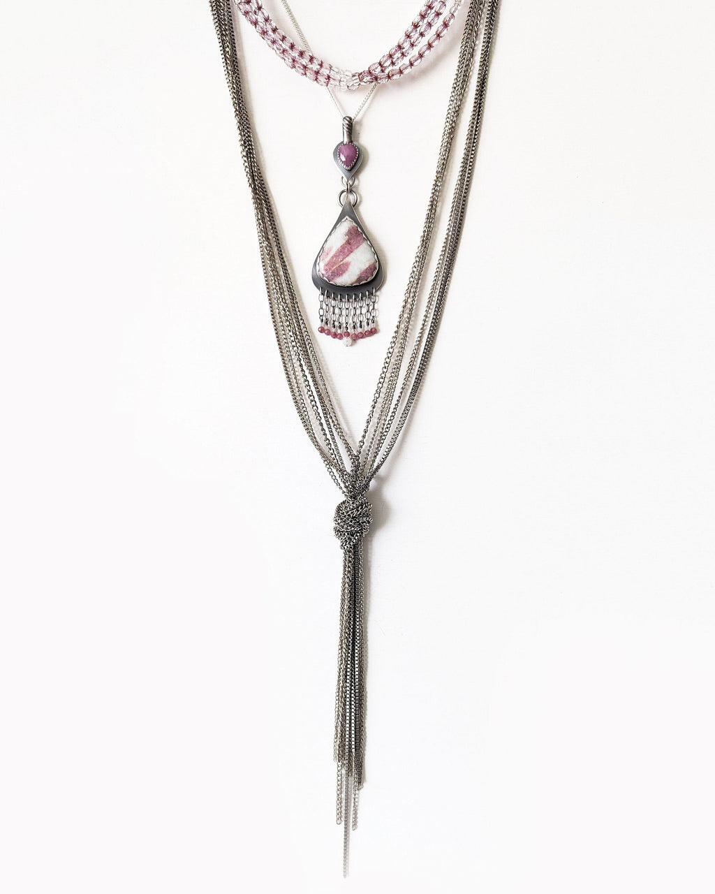 Quartz with natural pink tourmaline crystals accented by moonstone fringe detail shown with layering necklaces ad on chain (not included)