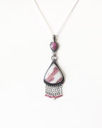 Close-up of rose cut pink sapphire set in oxidized sterling silver artisan pendant shown on chain (not included)