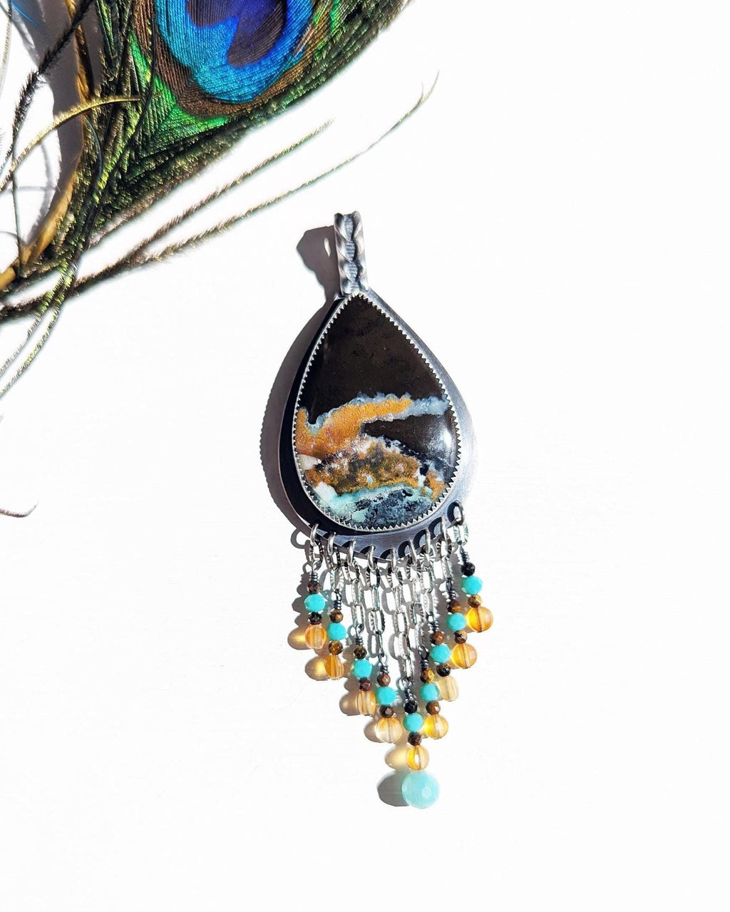 Opalized wood pendant with amazonite, carnelian, and tiger’s eye fringe