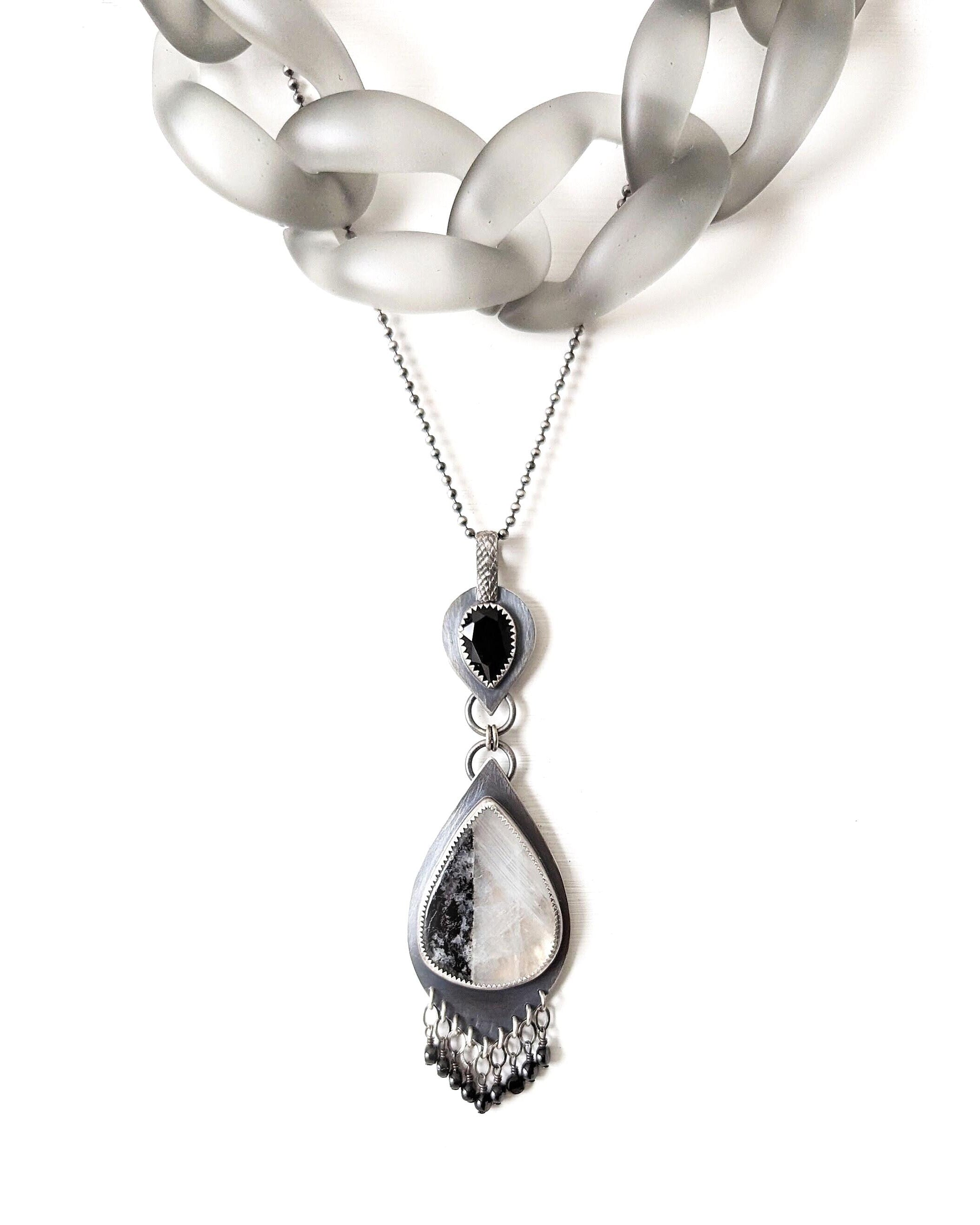 Video of Collector gemstone pendant featuring moonstone glow and onyx accent shown with layering necklace and on chain (not included)
