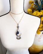 Vintage inspired palm root agate pendant with gemstone fringe shown on bust for scale