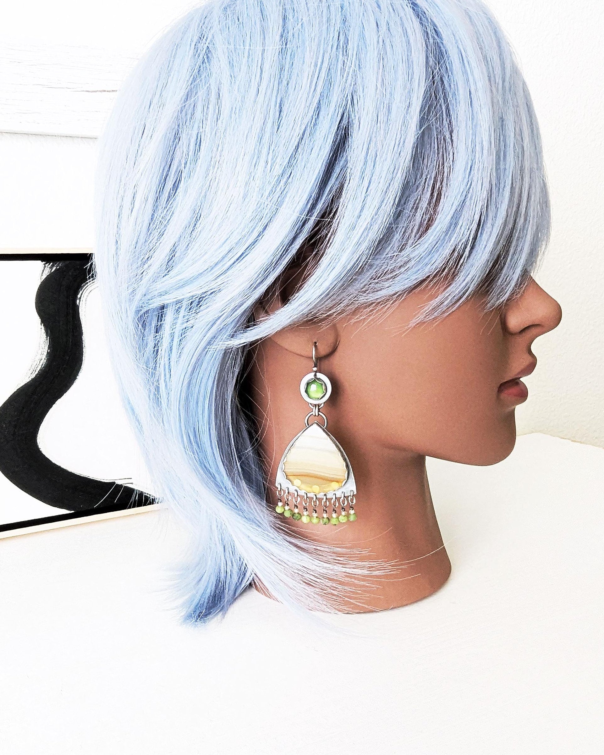 Earthy green and orange agate drop earrings with gemstone fringe on mannequin for size