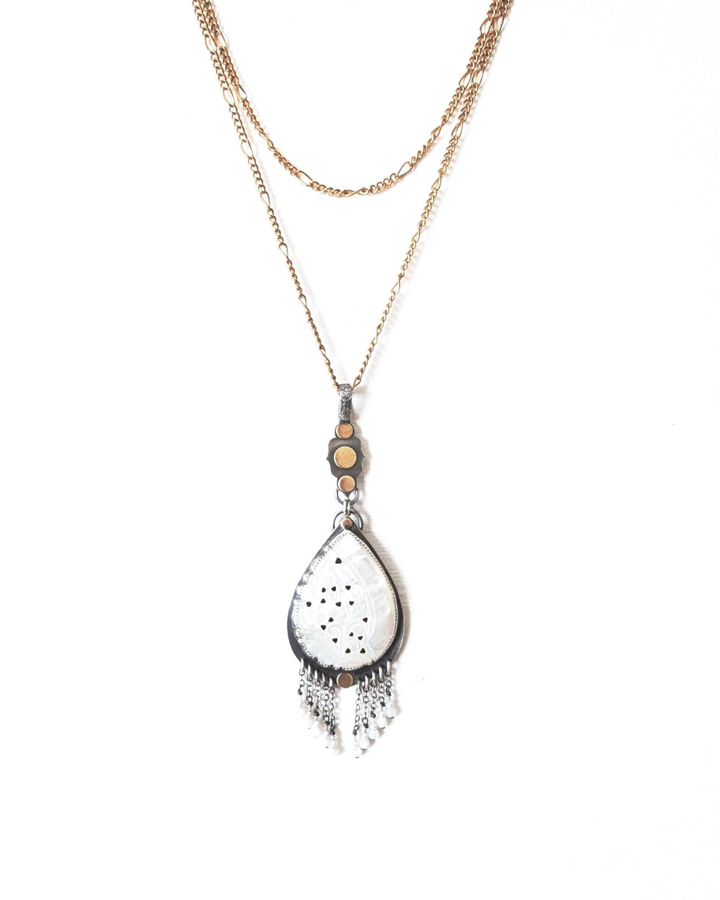 Organic style mother of pearl pendant with mixed-metal artisan design shown on chain (not included)