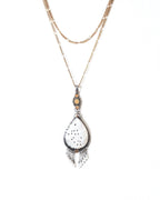 Organic style mother of pearl pendant with mixed-metal artisan design shown on chain (not included)