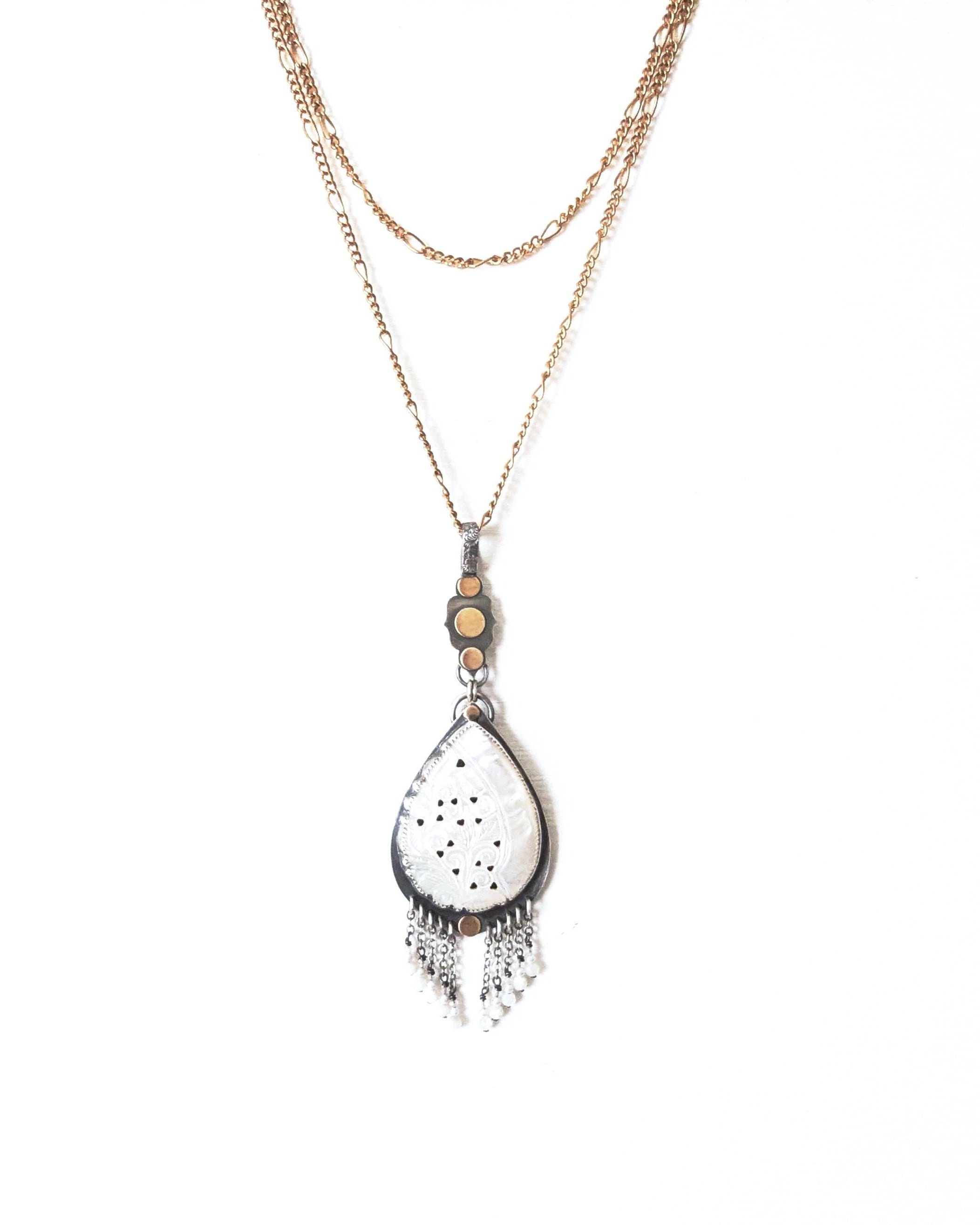 Organic style mother of pearl pendant with mixed-metal artisan design shown on chain (not included)