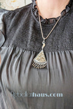 Triangular druzy pyrite pendant with flame-shaped handmade bail in oxidized silver shown on bust for size