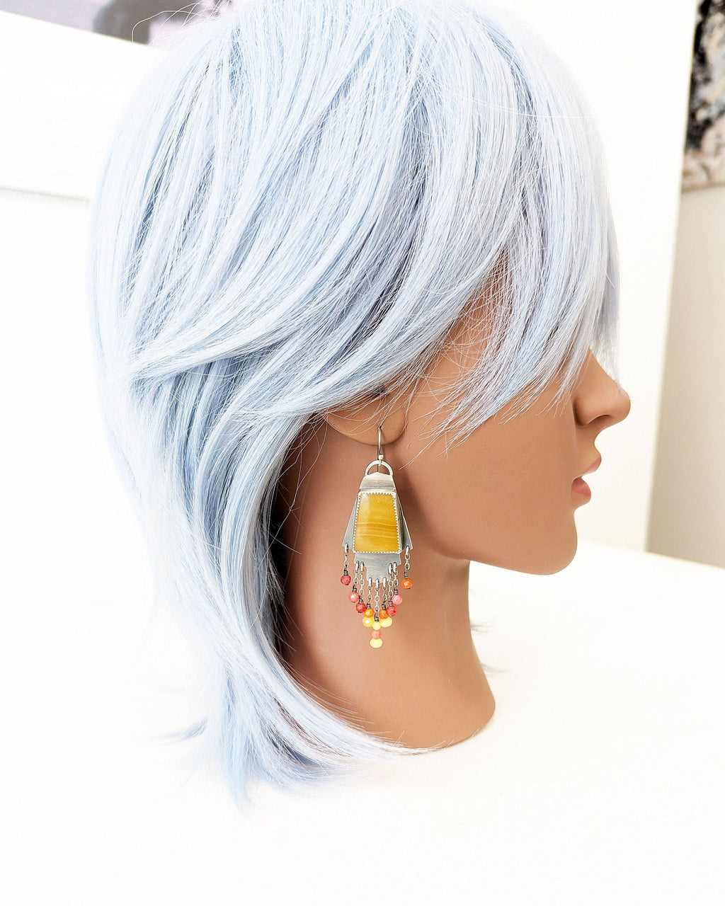Artisan dangle earrings featuring calcite and coral accents