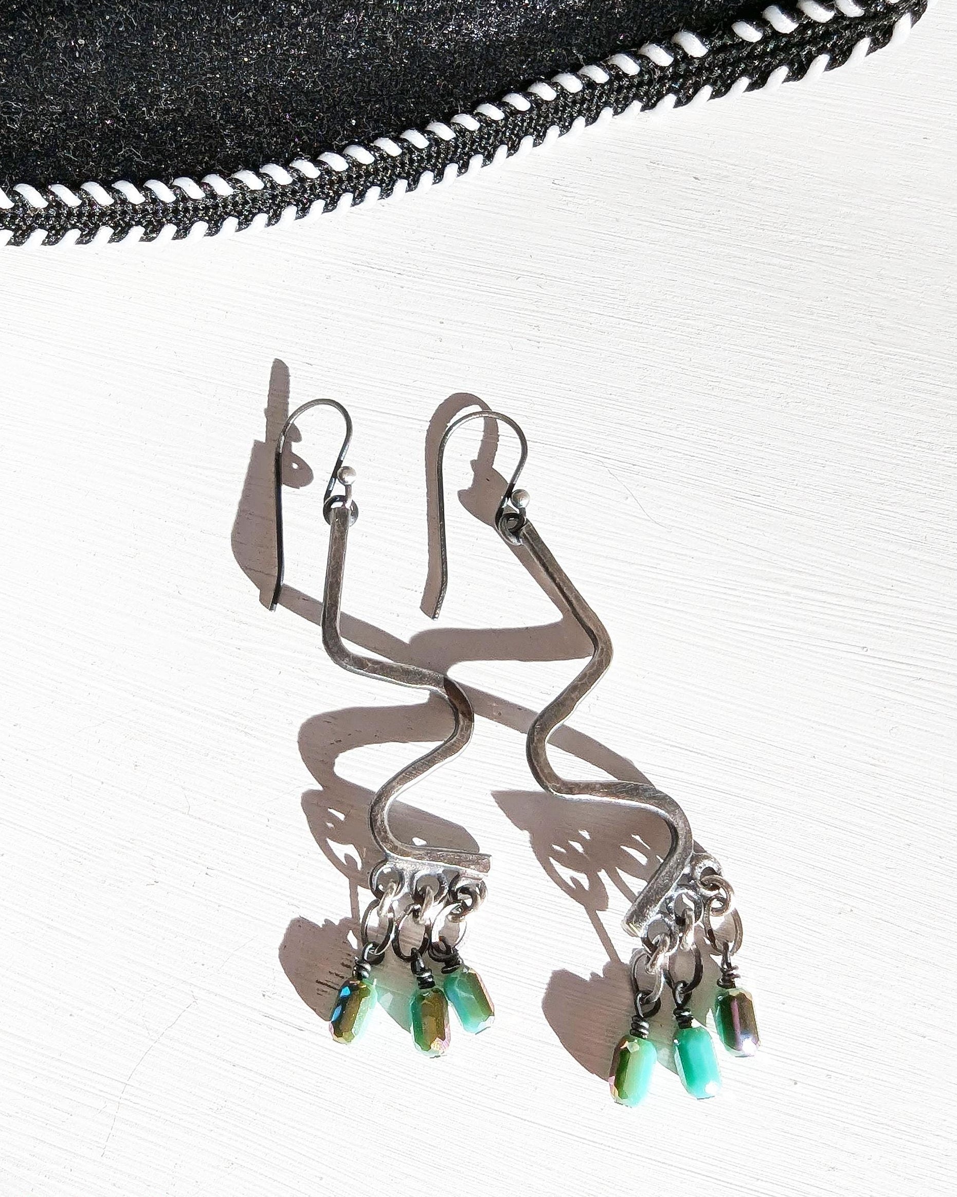 Playful artisan fringe earrings with turquoise blue metallic flashes