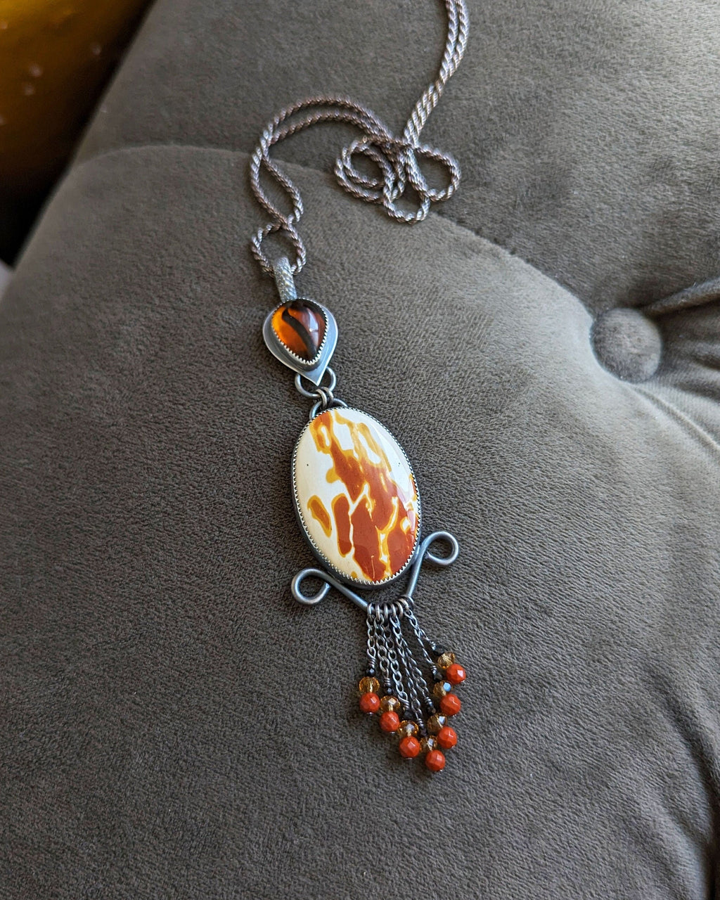 Pendant on a chain on a gray surface