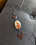 Pendant on a chain on a gray surface