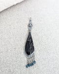 Close up of web patterned resin cabochon in sterling silver setting
