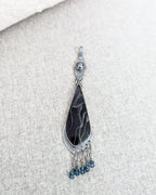 Close up of web patterned resin cabochon in sterling silver setting