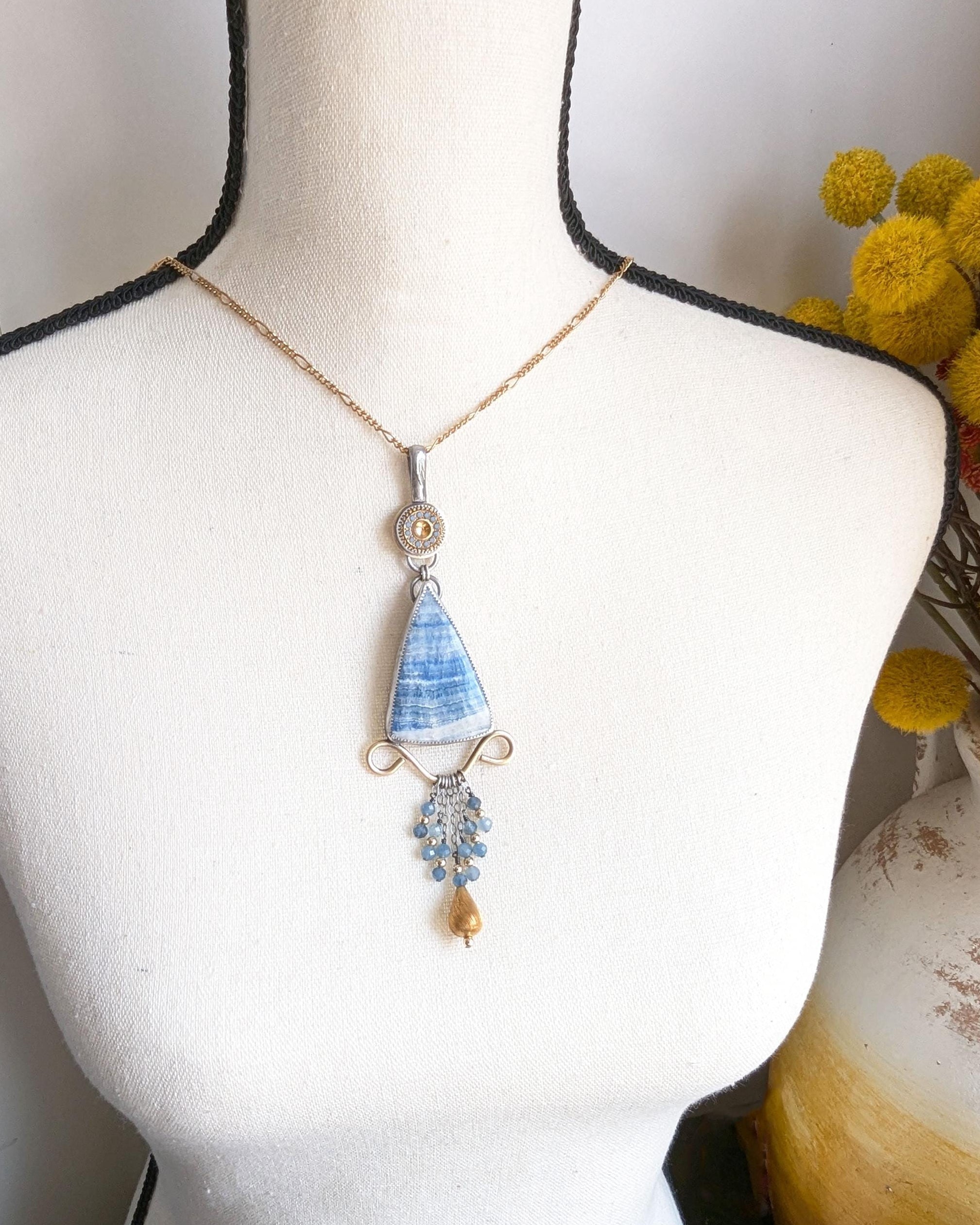 Collector mixed metal necklace featuring scheelite and vintage elements shown on bust for scale
