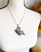 Butterfly pendant worn on silver chain for scale on bust.
