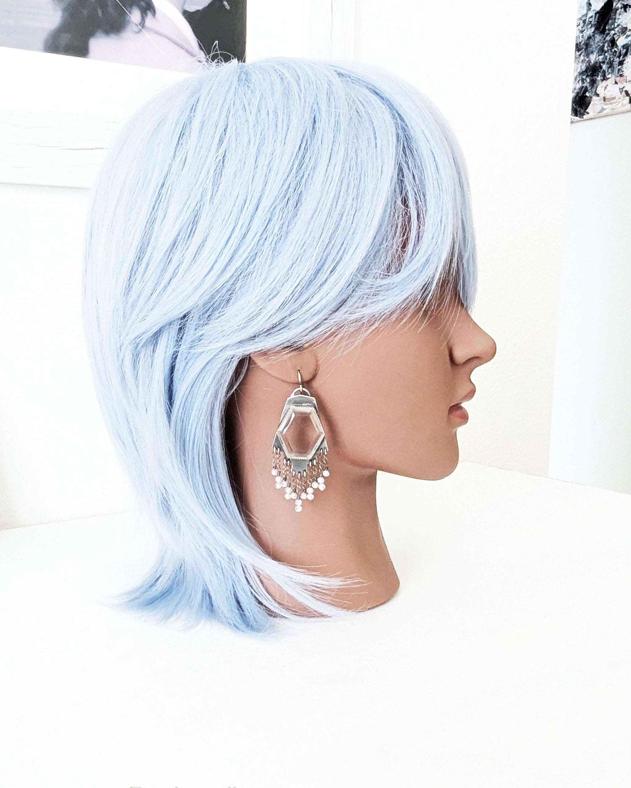 Large hydro quartz crystal earrings worn for scale on mannequin
