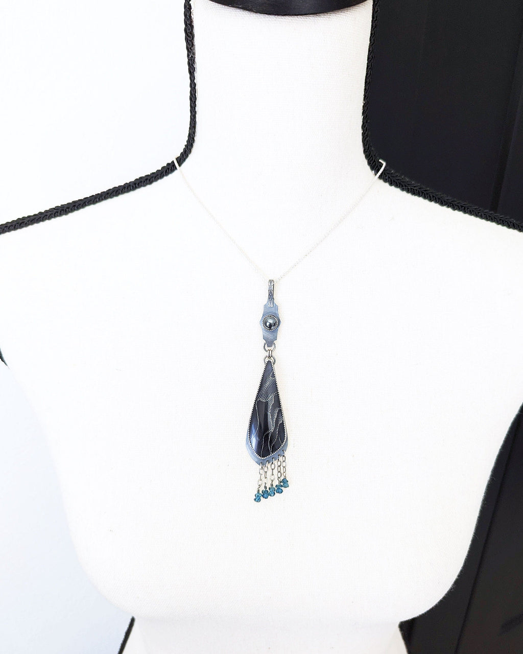 Gothic statement pendant with webbed resin cabochon and blue topaz beads on bust for size (chain not included)