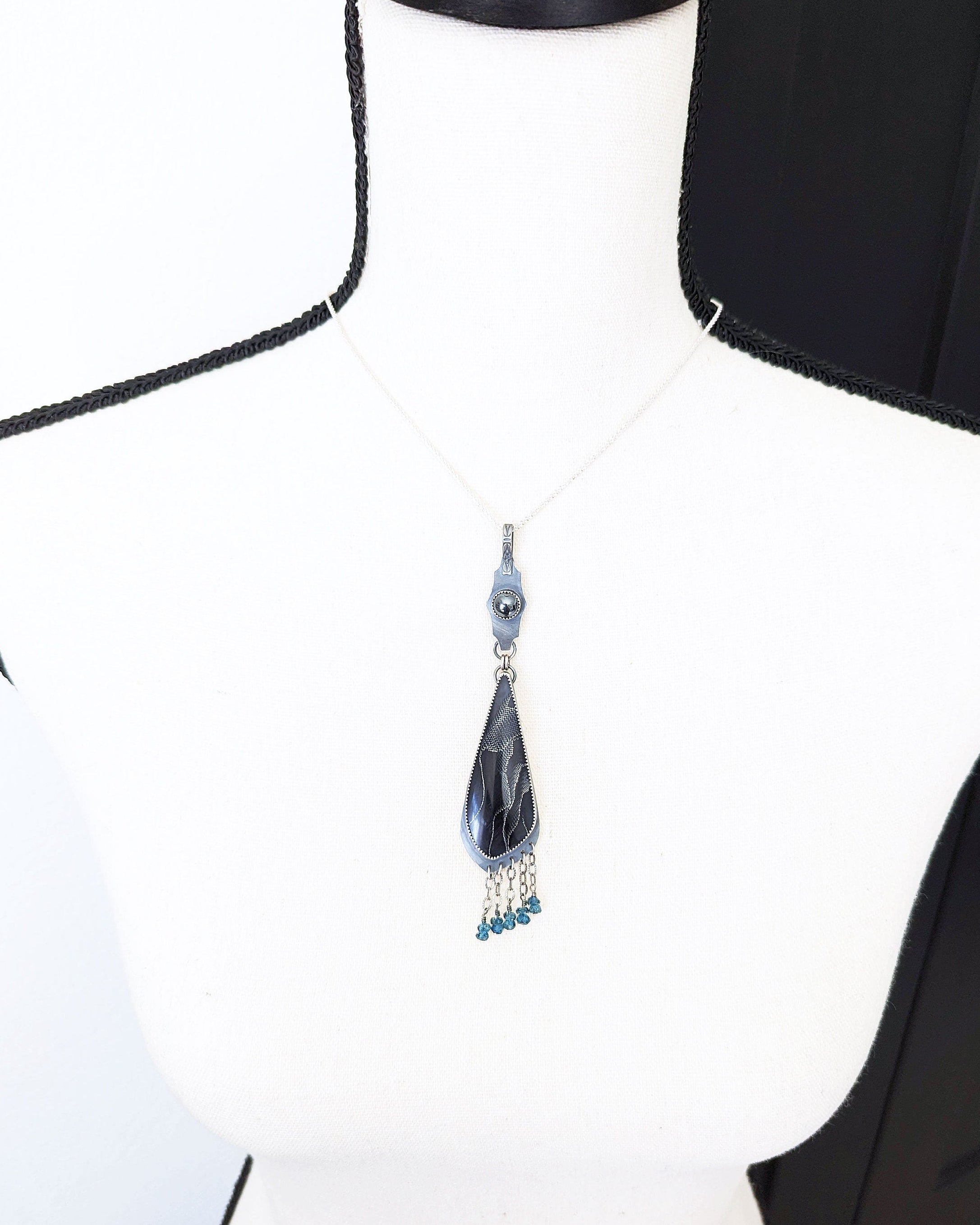 Gothic statement pendant with webbed resin cabochon and blue topaz beads on bust for size (chain not included)
