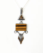 Close up of star rutile quartz crystal with golden rutile burst shown on chain (not included)